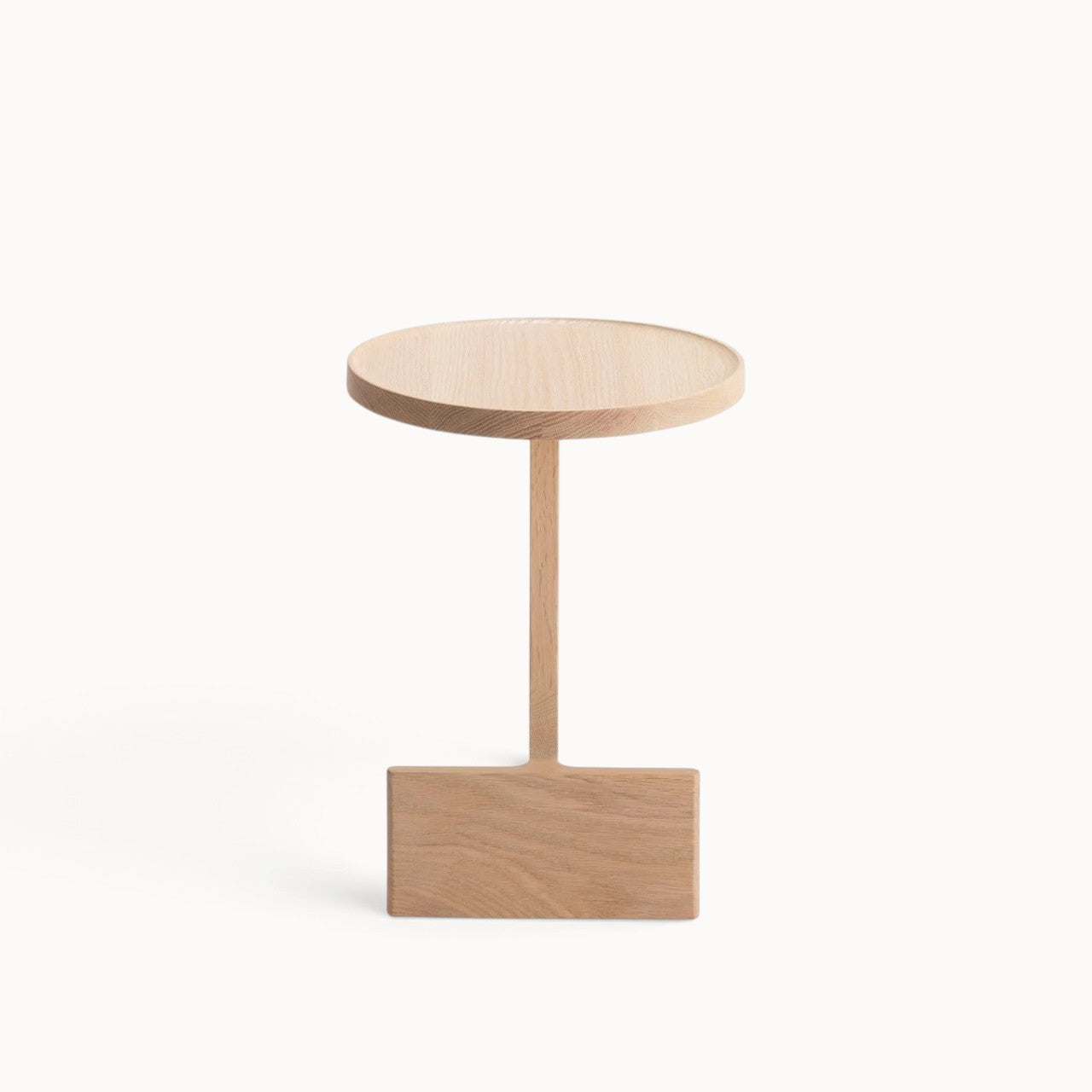hibino Beam side table in natural oak wood with a sculptural, minimalist design and a circular tabletop.