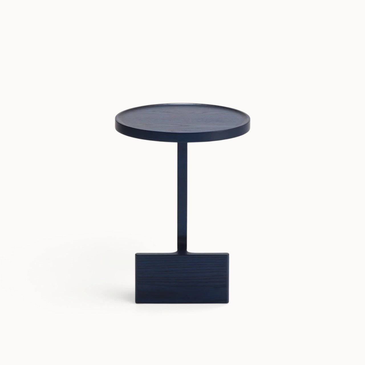 hibino Beam side table in dark blue wood with a sculptural, minimalist design and a unique beam-supported base.