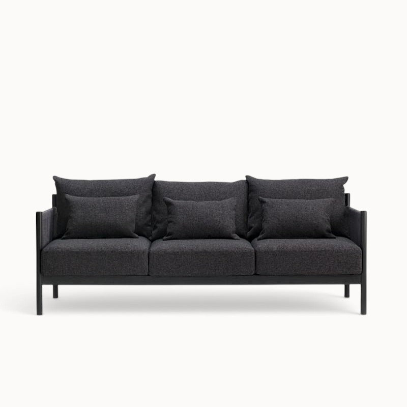 hibino Braid Sofa in dark charcoal grey fabric with a minimalist black frame and matching throw pillows