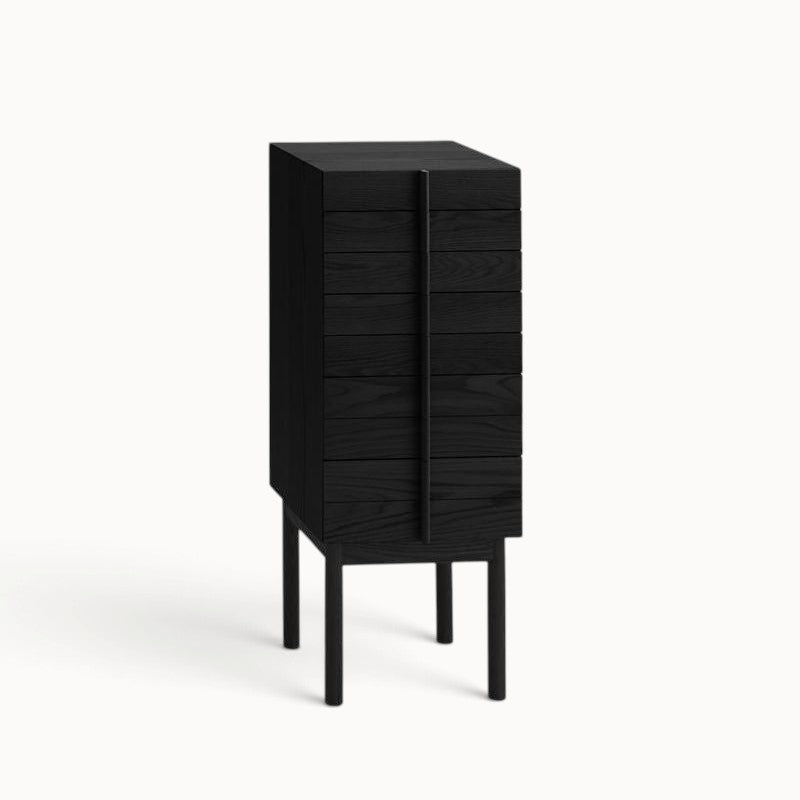 hibino Column Chest in black wood with a vertical handle design and raised legs for a minimalist bedroom aesthetic