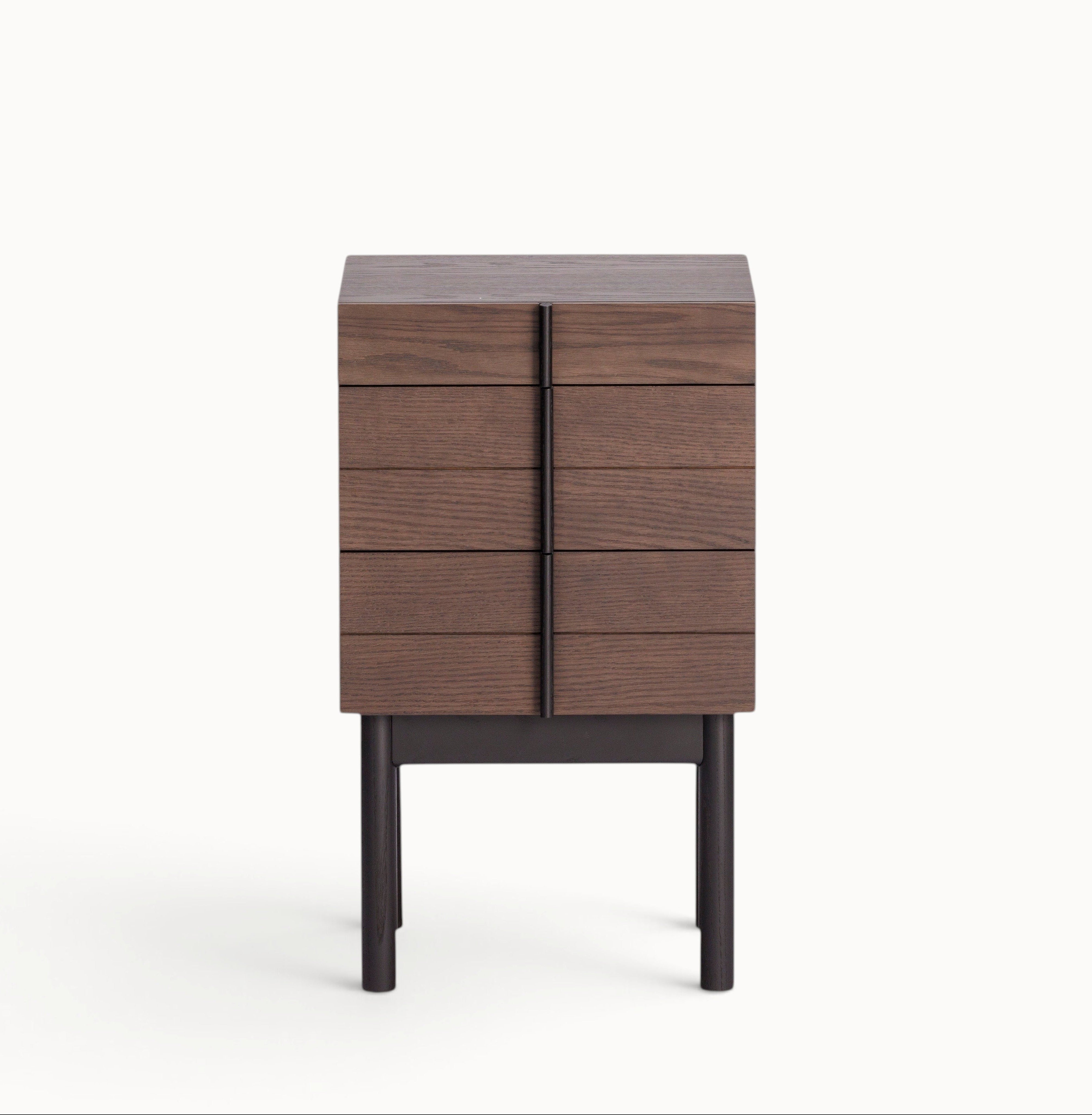 hibino Column Chest in dark wood with vertical aligned drawer handles and elevated legs on a white background