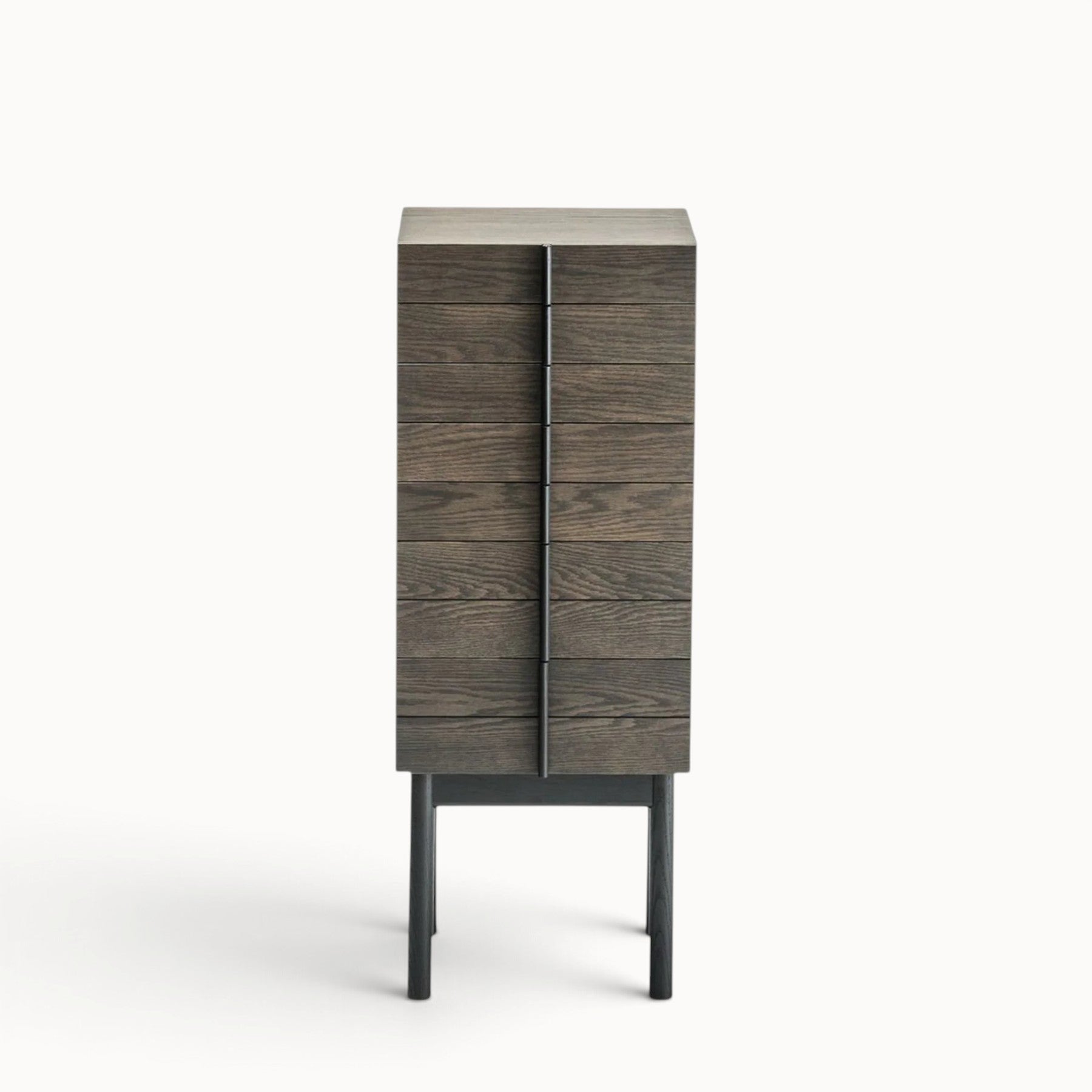 hibino Column Chest featuring dark wood drawers with vertical dovetail handles on tall slender legs