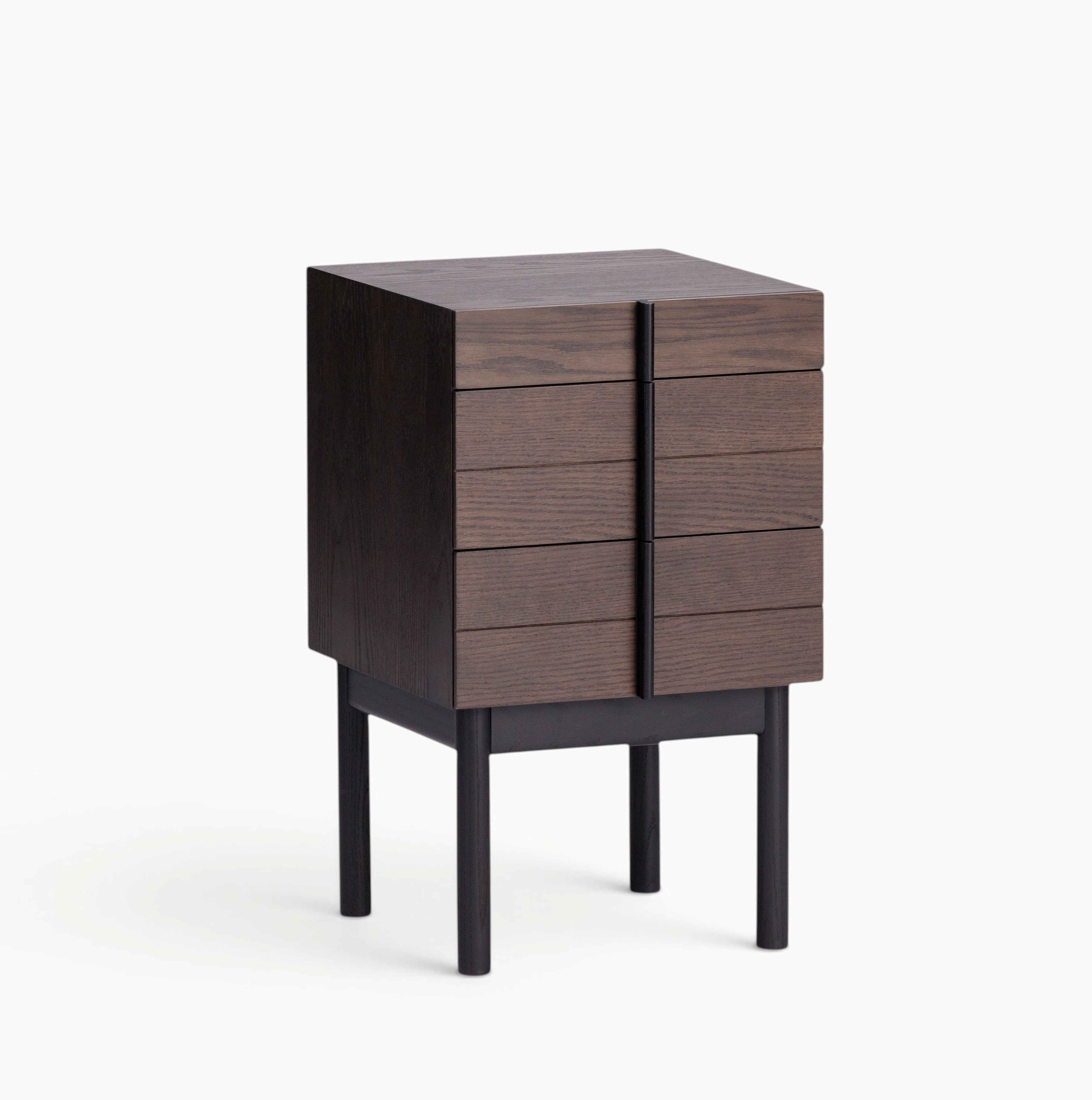 hibino Column Night Table in dark wood with vertical drawer handles and elevated legs on a white background