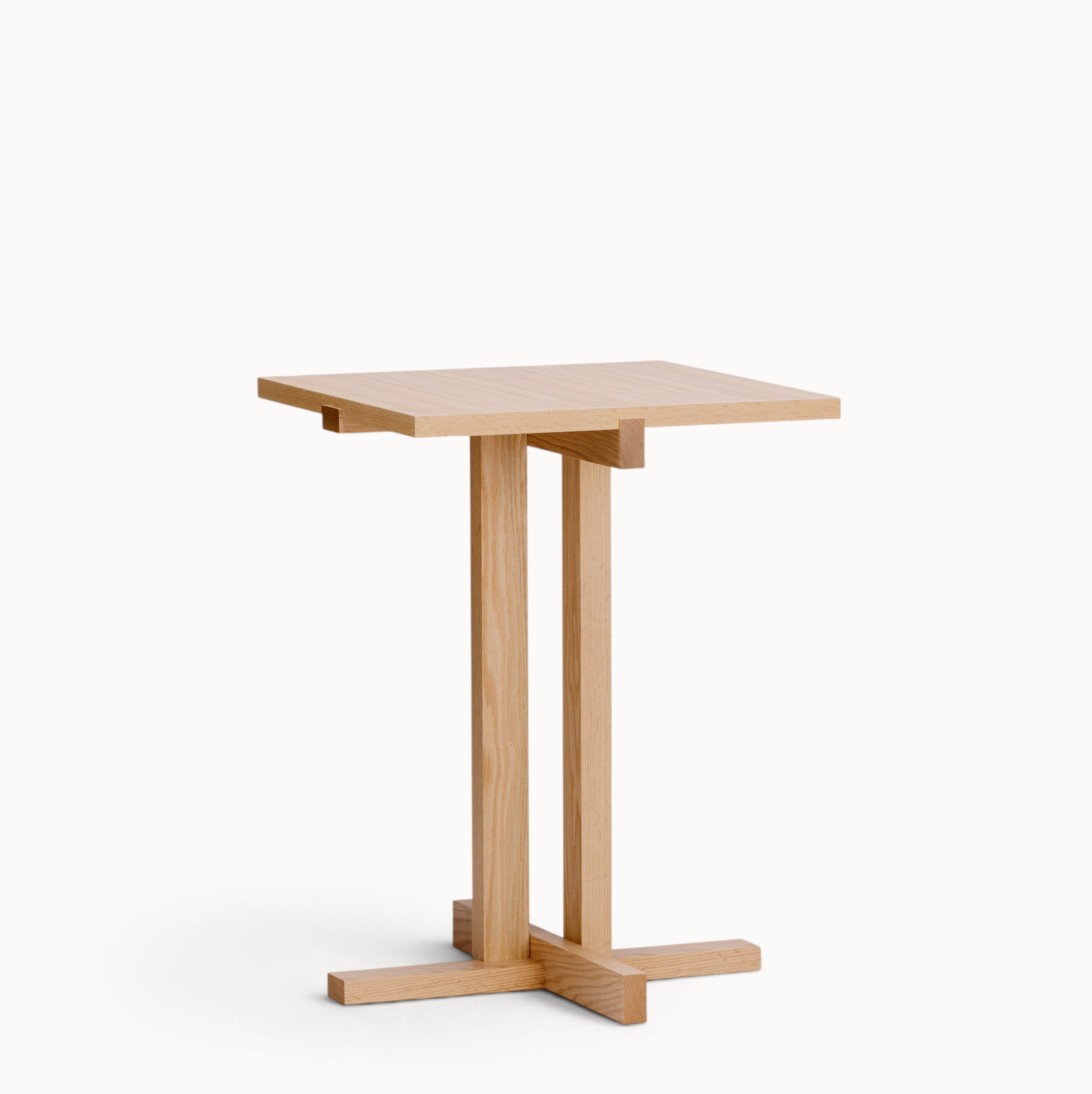 hibino Elements table in natural oak wood with a minimalist square top and geometric cross-base design