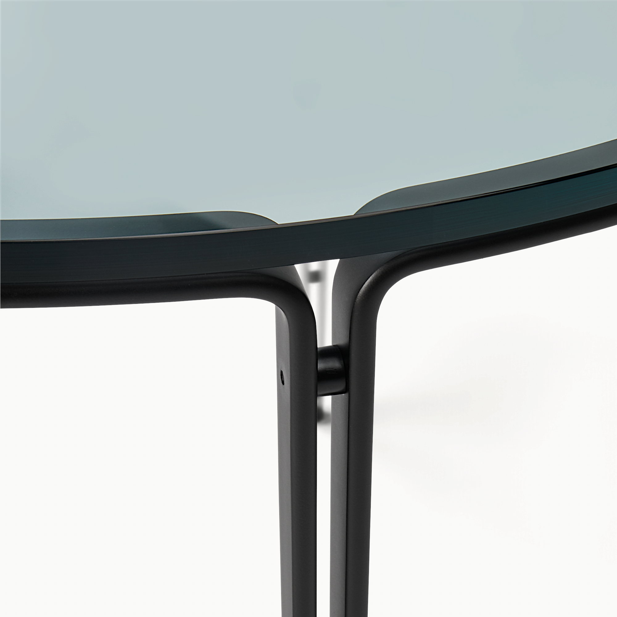 hibino FK110 round coffee table featuring a minimalist black steel frame and a sleek glass top