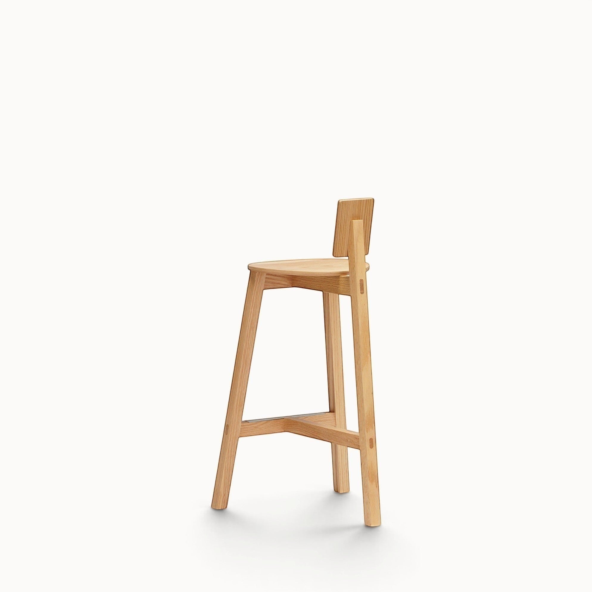 hibino Homage counter stool in natural oak wood with a minimalist T-shaped frame and low rectangular backrest