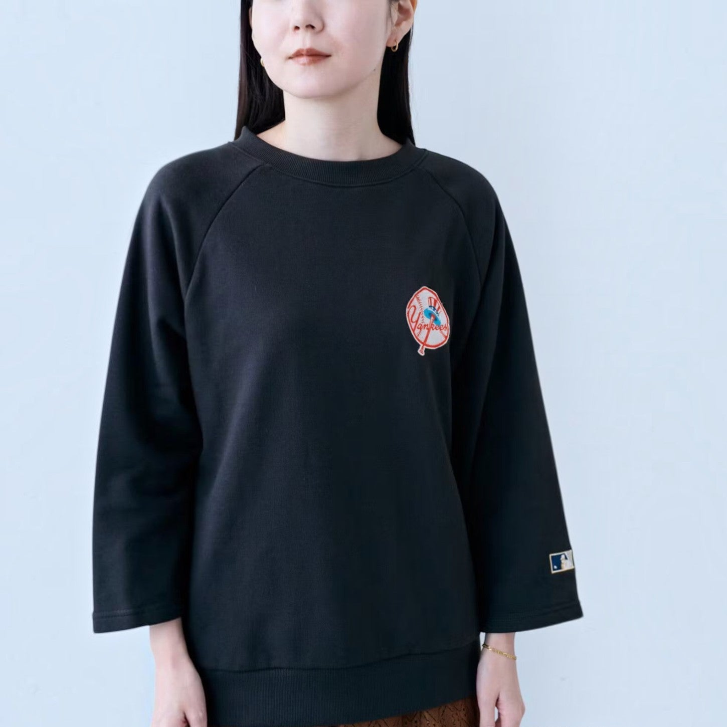 hibino charcoal black New York Yankees Cooperstown Collection sweatshirt with three-quarter sleeves on a woman