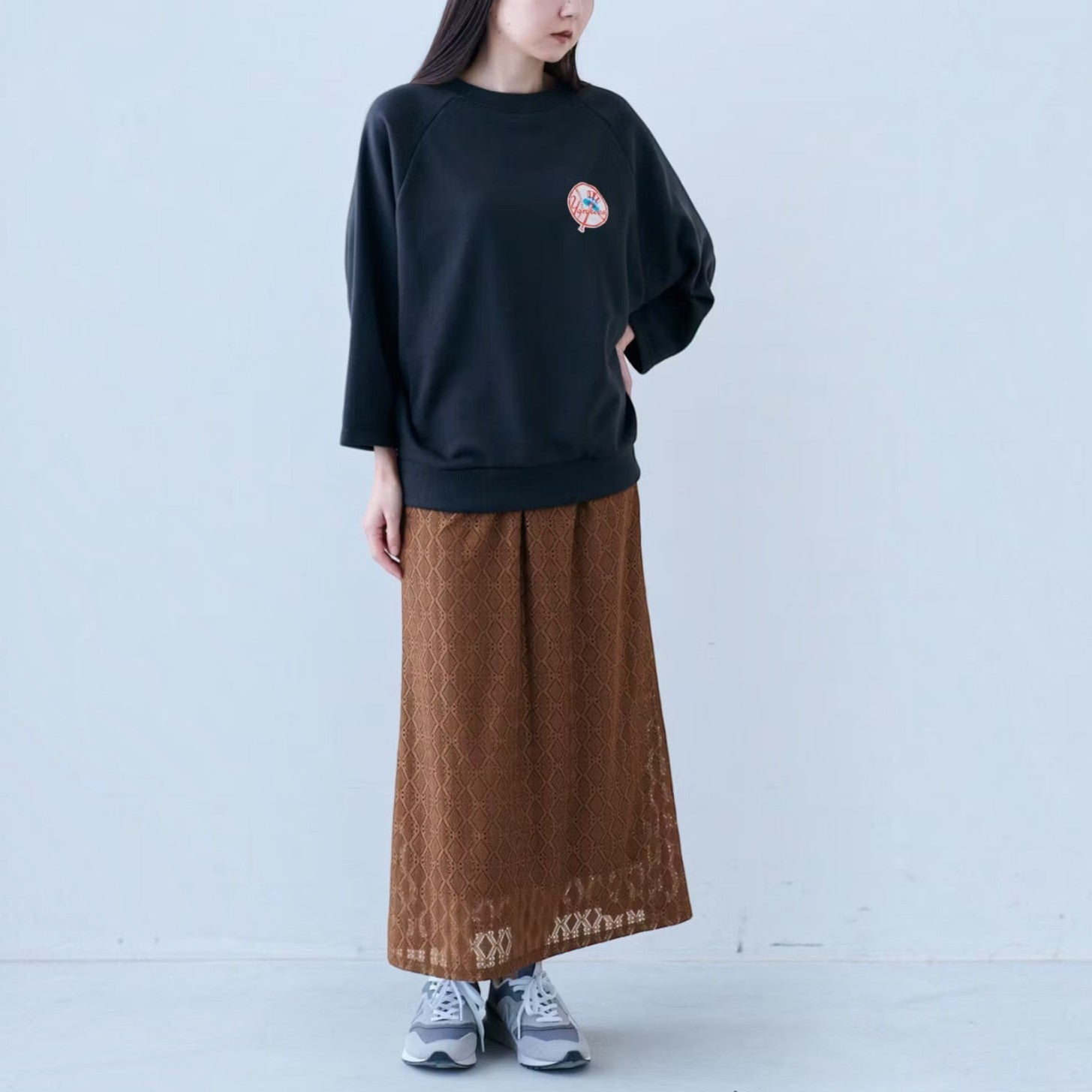 hibino charcoal black New York Yankees Cooperstown Collection sweatshirt with three-quarter sleeves on a woman