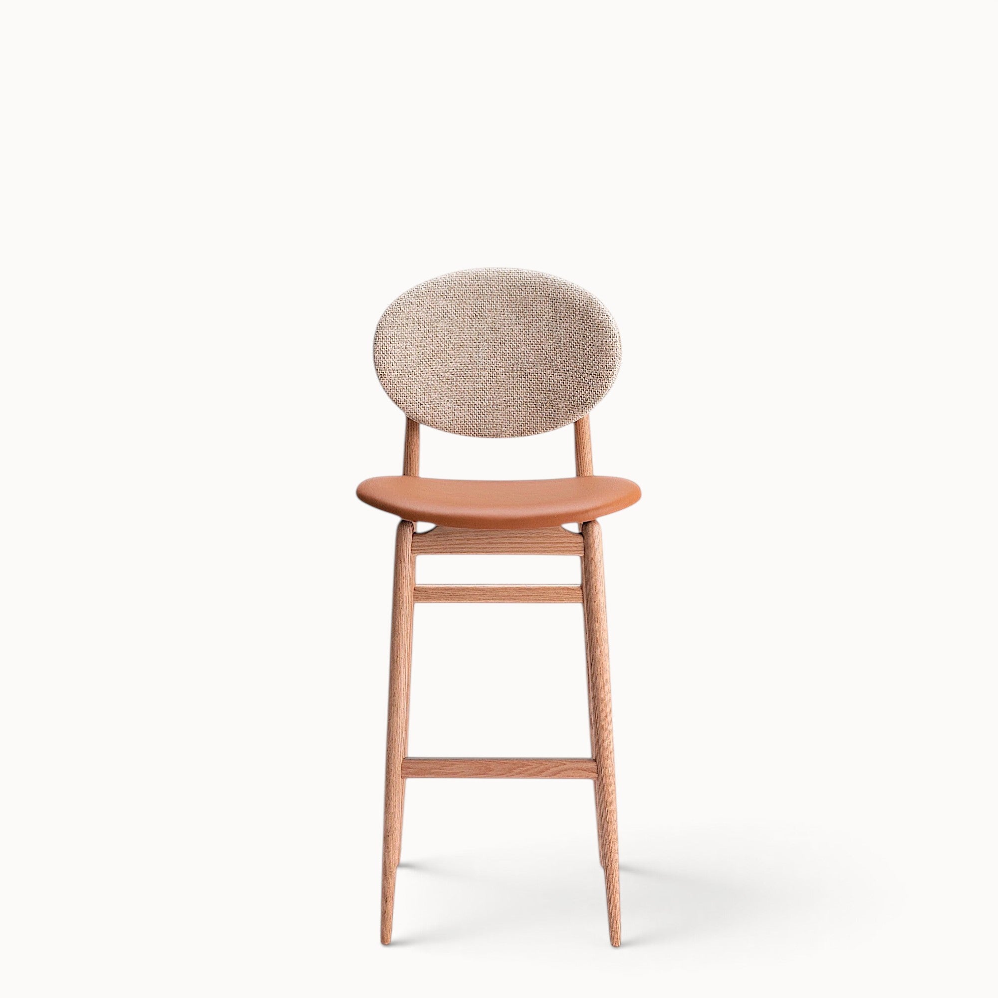 hibino Outline Barstool with a light oak wood frame, tan leather seat, and a beige fabric circular backrest.