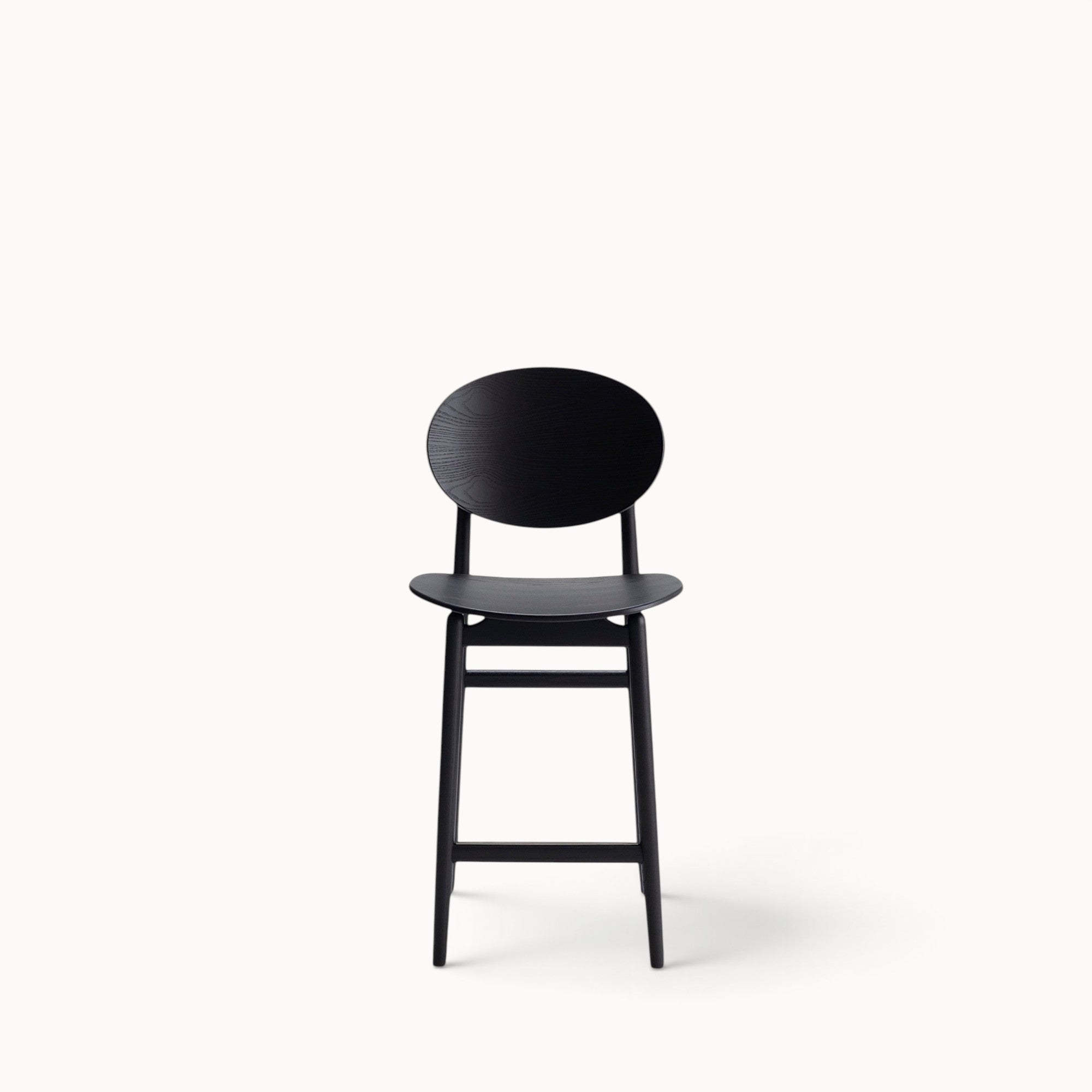 hibino Outline Barstool in matte black wood with a curved backrest and minimalist design on a white background