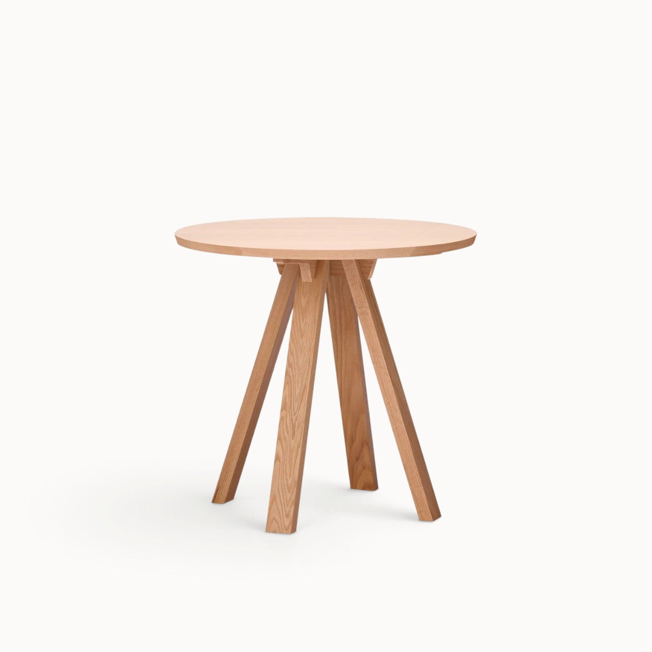 hibino Sagyo round table in natural oak wood with a minimalist design and sturdy angled legs