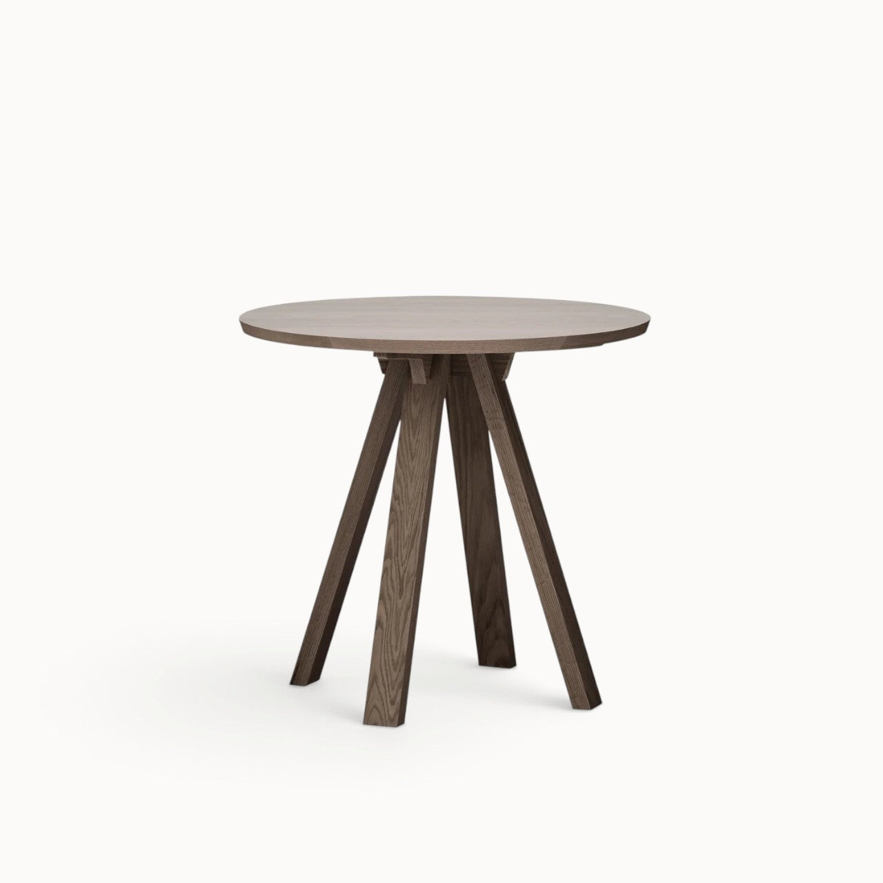 hibino Sagyo round wooden table in a dark oak finish with a minimalist design and angled legs