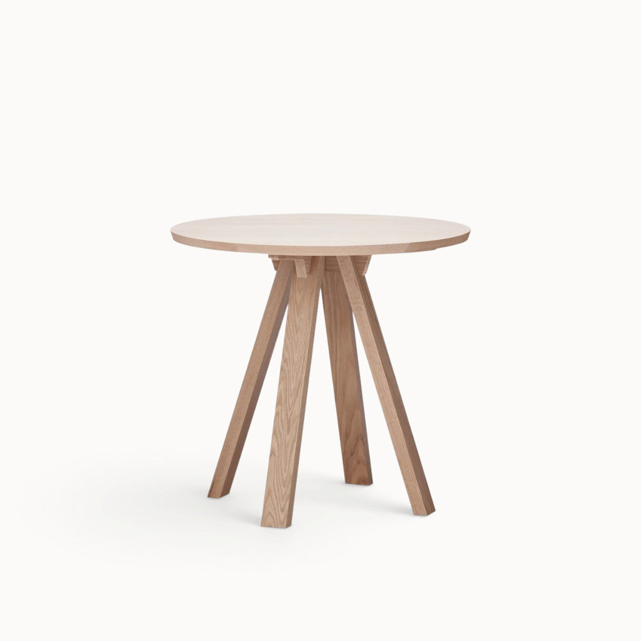 hibino Sagyo round table in natural oak wood with a minimalist design and sturdy angled legs