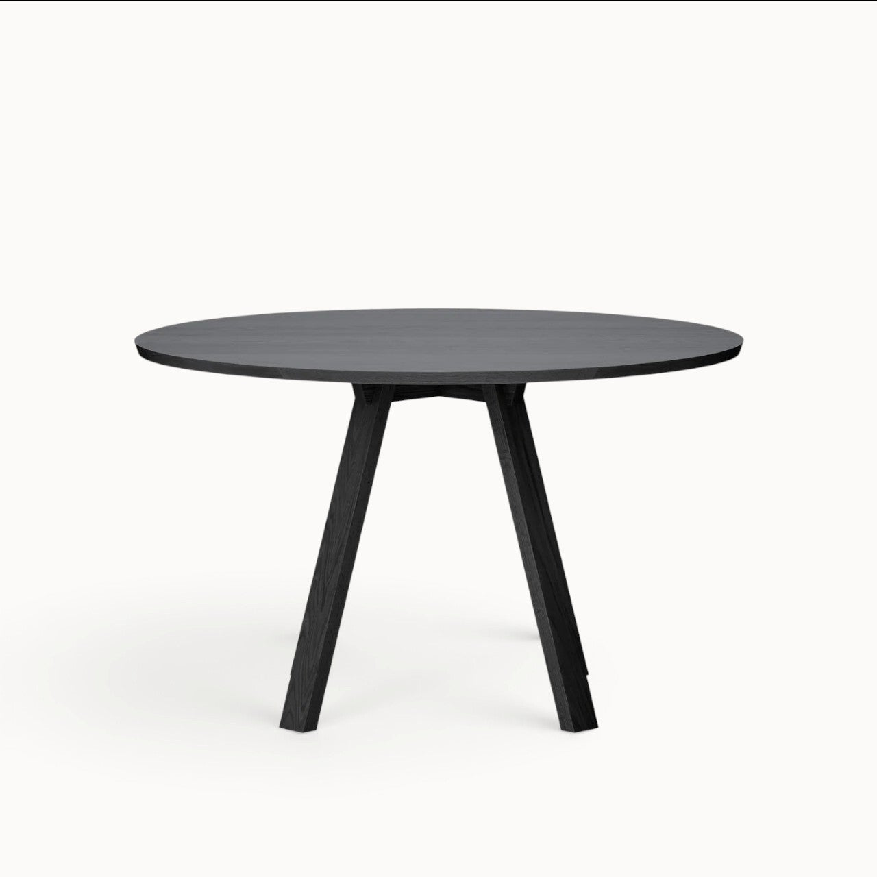 hibino Sagyo round table in black Sumi ash wood with a minimalist design and split tabletop surface