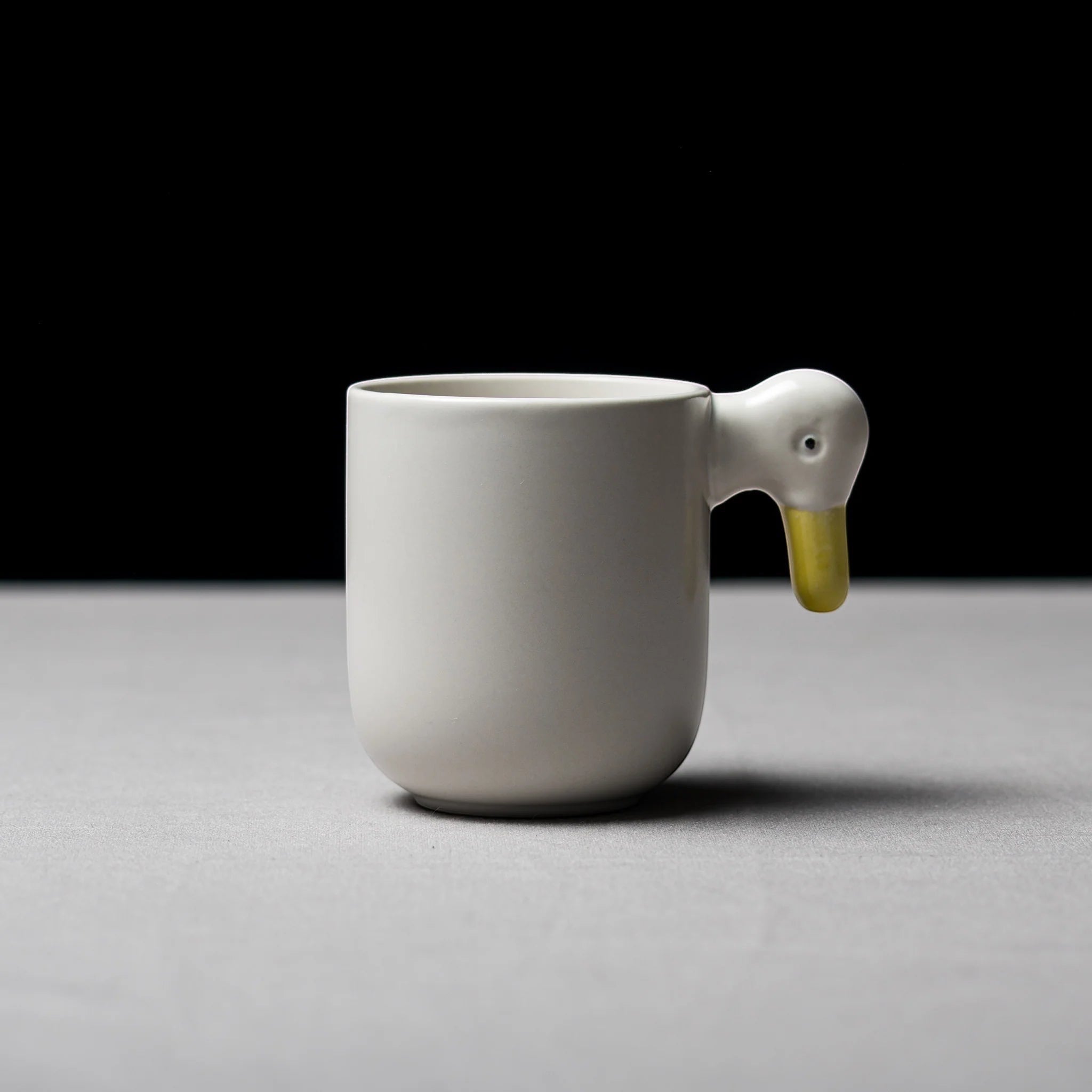 hibino ceramic mug in white with a unique duck head shaped handle featuring a yellow beak